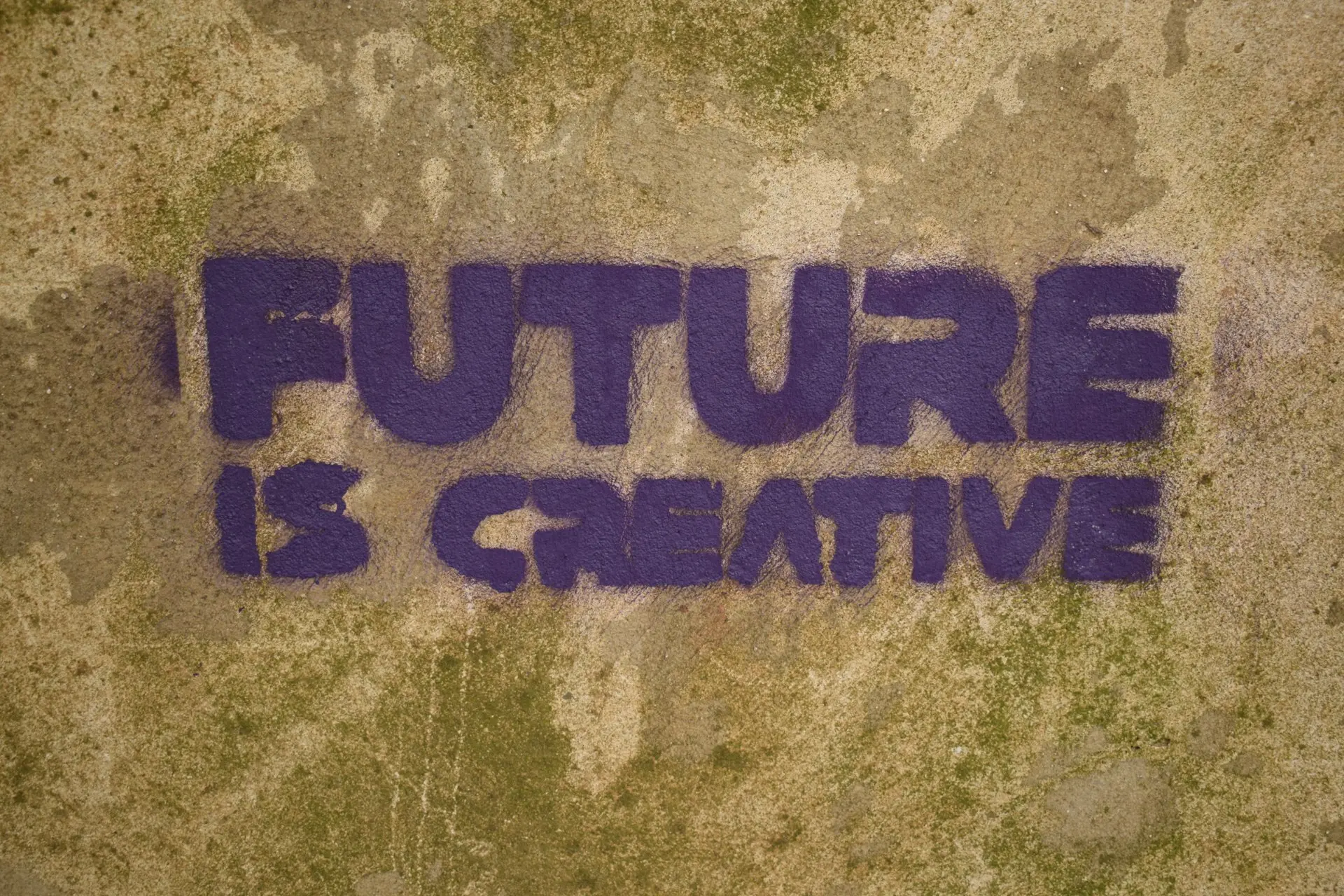 The words "FUTURE IS CREATIVE" painted on a wall